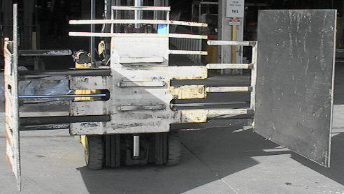 One of 3 Long Reach MFG forklift squeeze box stack handling